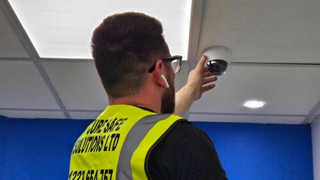 Man inspecting a CCTV camera