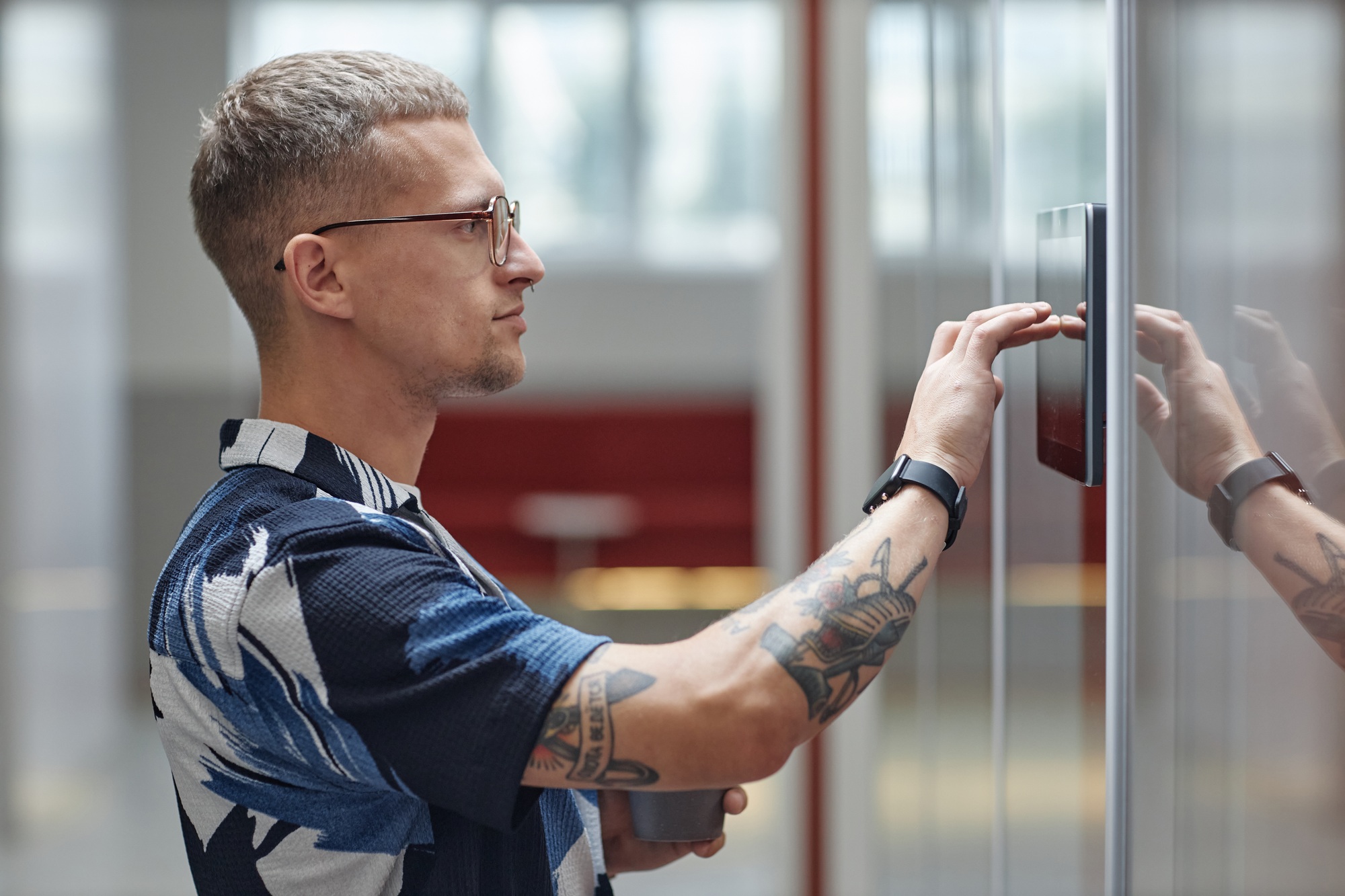 Man Unlocking Office Room with Access Code Indoors Using Smart Wireless Control Panel