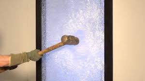 Sledgehamme breaking through security glass